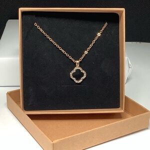 Beautiful Black and gold tone clover necklace. With rhinestone accents